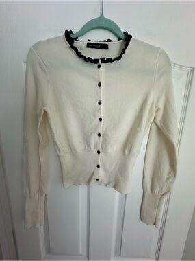 The Limited Cream Cardigan with Black Ruffle Trim